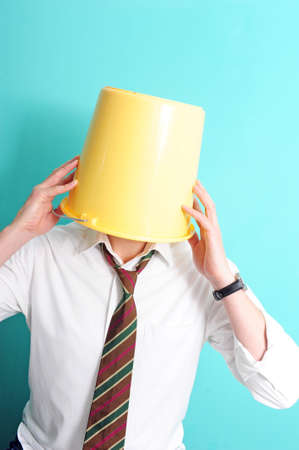 Man with yellow bucket on his headの写真素材