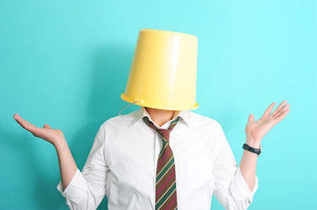 Man with necktie and bucket on his head の写真素材