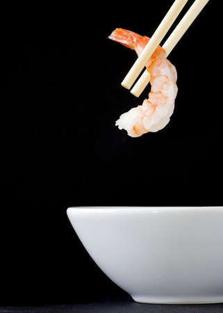 Picking up prawn using chopsticksの写真素材