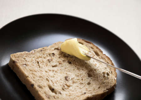 Granary Bread being Spread with Butter