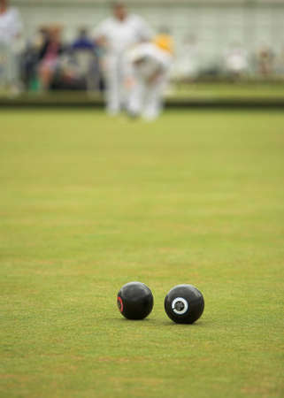A game of lawn bowls. Focus on the woods.の写真素材