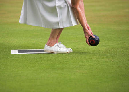 A mature lady player playing lawn bowls.の写真素材