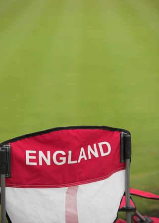 An England chair next to a manicured lawn.の写真素材
