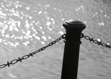 Steel bollard and chain by the の写真素材