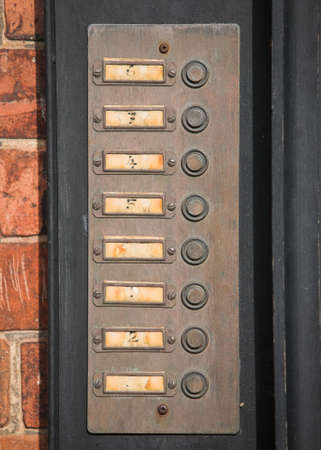 Row of numbered door bell buttons on a wallの写真素材