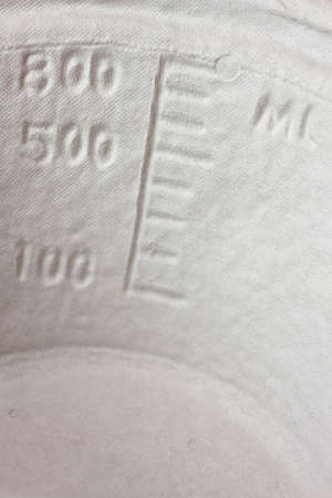 A disposable papier mache vomit bowl with markings to measure volume.の写真素材