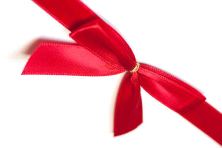 A red ribbon, tied in a bow on a white background. の写真素材