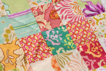 Detail from a handmade patchwork quilt made with squares.の写真素材