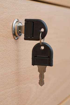 Office drawer with key in lock and spare keyの写真素材