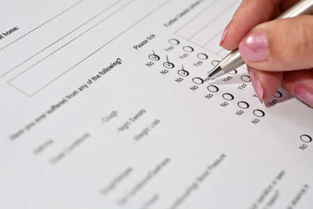Female job applicant completing a health questionnaireの写真素材