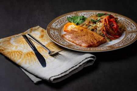 Grilled halibut steak with vegetablesの写真素材