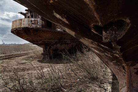 Old rusty river ship on the shore