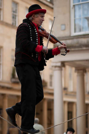 Bath, UK 03/06/2010: A very talented man in  black and red costume is performing a skill show by...