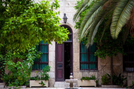 Damascus, Syria 03/28/2010: An old house called Maktab Anbar which was built in the famous  Damascene style in 19th century. Image was taken from the courtyard featuring a door, trees and a fountain.のeditorial素材