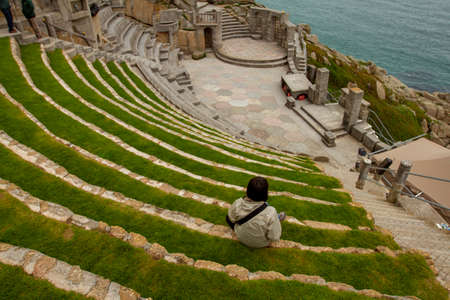 Penzance, UK 03/10/2010: Aerial view  of the Minack Theatre, a unique amphitheater carved in a rocky slope by Atlantic ocean. This terraced stone building is a very popular performance destination.のeditorial素材