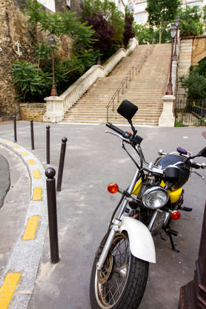 Paris, France 06/13/2010: Close up view of a yellow shiny MZ motorbike parked on the sidewalk by a...