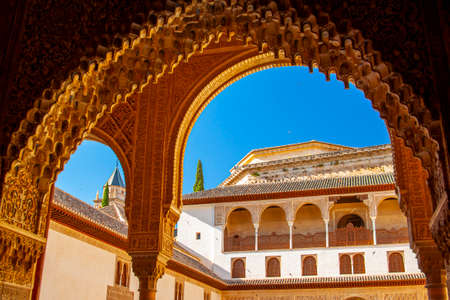 Granada, Spain 07/13/2010: View of the famous Alhambra Palace through a gate with decorative Islamic...