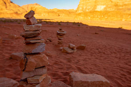 An abstract image of sand stones stacked up in tower shape. Stones are rough with detailed texture yet they balance in great harmony and make a pyramid shape. Useful demonstration for zen meditation.の写真素材