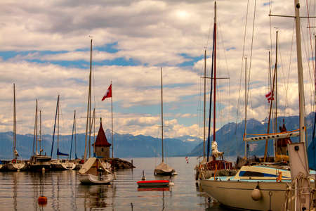 A landscape view of the marina on the coast of Lake Geneva, Switzerland. Clear waters of the lake, a...