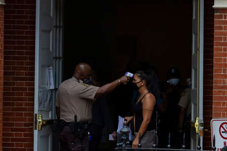 Annapolis, MD 08/21/2020: Police officers with Sheriff badge, wearing face mask are on duty at the...