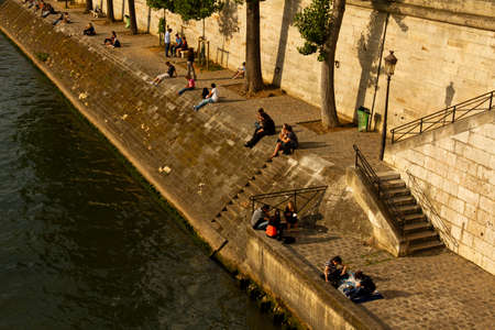 Paris/France 06/13/2010: Parisians are enjoying the beautiful weather by sitting by the banks of Seine river in a sunny afternoon (aerial view)のeditorial素材