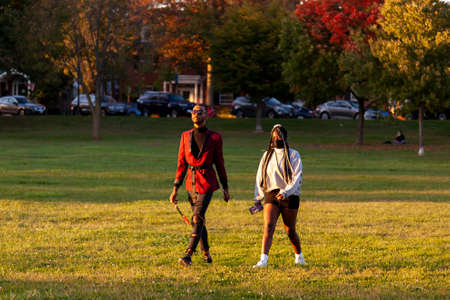 Frederick, MD, USA 10/14/2020: A young African American couple wearing fashionable clothes is...