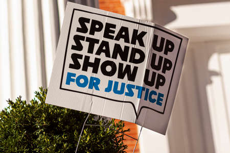 An anonymous yard sign that says: Stand up, speak up, show up for justice referring to recent events...