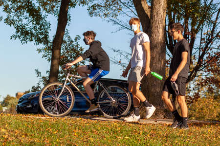 Frederick, MD, USA 10/14/2020: A group of caucasian teenager boys are hanging out in the...