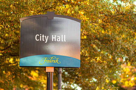 Frederick, MD, USA 10/13/2020: Frederick is a picturesque historic town in Maryland and the county seat of Frederick County. Signpost shows City Hall where local government officials work.のeditorial素材