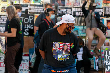 Washington DC, USA 11/06/2020: Crowd gathered at Black Lives Matter Plaza near White house celebrate Joe Biden's victory in US elections. An African American man in Biden Harris T-shirt is among themのeditorial素材