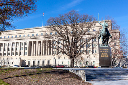 Washington DC, USA 11-29-2020: The headquarters of the US department of the interior building with the famous statue of Simon Bolivar "the liberator" in the park in front of the building.のeditorial素材