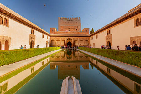 Granada, Spain 07-12-2010: Alhambra Palace complex Reflection pool with the reflection of the palace in the dark waters. Image features the bush fences,  Nasrid palace, courtyard garden and the poolのeditorial素材