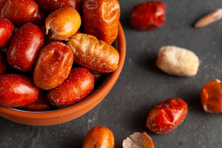 Ripe fruits of cultivated eleagnus (silverberry) plants. The nut sized brown fruit has a thin skin....
