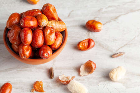 Ripe fruits of cultivated eleagnus (silverberry) plants. The nut sized brown fruit has a thin skin....