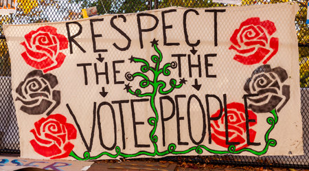 Washington DC, USA 11-08-2020: A political banner hanging on chain fence near White House after election says: " Respect the Vote, Respect The People " It has socialist rose emblems on it.のeditorial素材