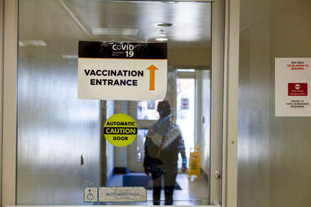 Image showing the Inside of a healthcare facility featuring Glass automated door with a sign taped...