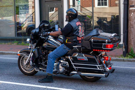 Annapolis, MD, USA 05-02-2021: An African American man with  beard wearing jeans, converse shoes,...