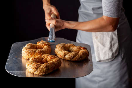 delicious Turkish bagel with sesame seeds known as susamli simit. Served hot out of stone oven on...