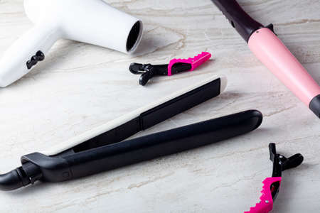 A collection of household tools used for DIY hairdo at home or in salon. The set includes curling...