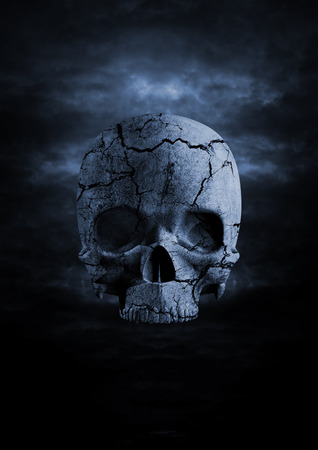 Dark skull  3D render of cracked stone skull in night skyの写真素材