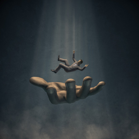 Catch my fall  3D render of businessman in suit falling into large handの写真素材
