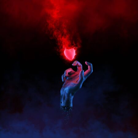 The fleeting heart / 3D illustration of hand grasping at burning heartの写真素材