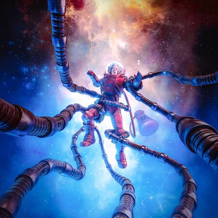 The terror beyond the stars of retro pulp science fiction scene showing female astronaut captured by tentacled monster in outer spaceの写真素材