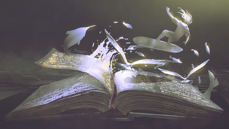 opening the magic book on dark backgroundの写真素材