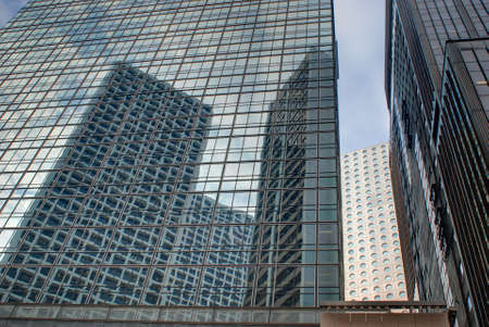 Office buildings reflect sunlight in financial district.の写真素材