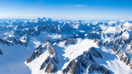 Aerial view of Alps mountains covered with snow and blue sky.の素材