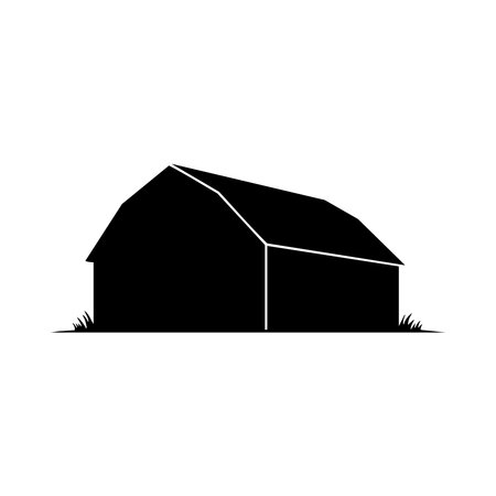 A striking black silhouette of a barn stands against a clean white background. The image features a distinctive silhouette style with a touch of grass at the base.のイラスト素材