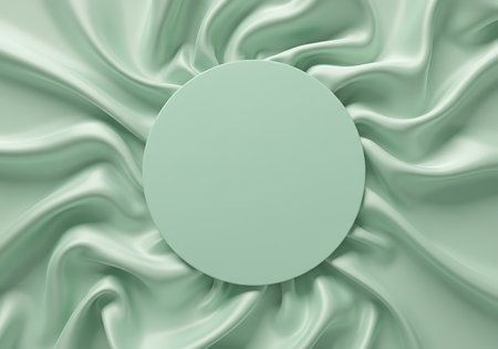 A flat lay image featuring a mint green oval shape placed centrally on a background of rippling, light mint green silk fabric.の素材