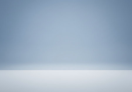 A clean, minimalist studio backdrop with a subtle blue gradient fading to white at the bottom, perfect for product placement.の素材