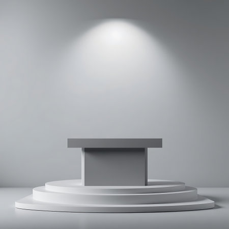 A clean, modern stage with tiered levels and a bright spotlight creating a dramatic focal point.の素材